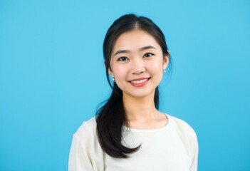 Portrait of an Asian woman on a bright blue background