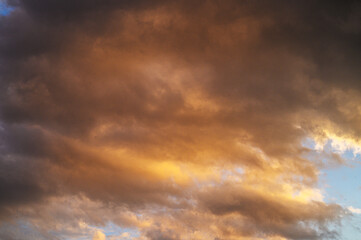 Majestic sunset sky painted in hues of orange and gold over a tranquil landscape