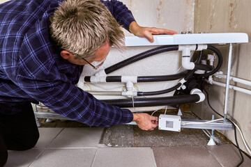 Adjusting plumbing and electrical connections wenn installing whirlpool jet tub.
