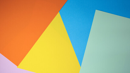 Creative arrangement of colorful papers on a pastel backdrop