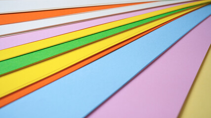 Colorful sheets of paper arranged in a creative display at midday