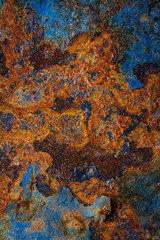 Rusty metal surface with shabby background paint. Blue cracked paint texture on an iron sheet. Fragment of an old metal door, Metal corrosion.