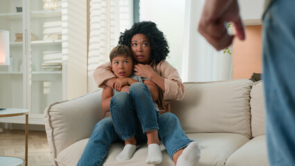 Domestic violence abuse in multiracial family scared woman protect kid child from aggressive drunk...