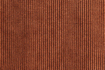 Fototapeta premium Brown velvet fabric texture background. Brown cloth. Fabric surface for designs. Top view.