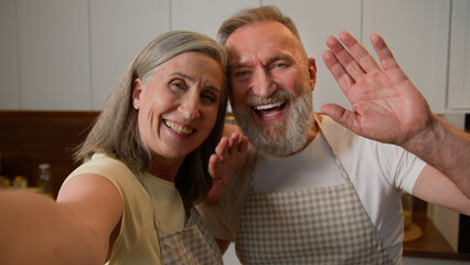 Webcam view happy senior retired family couple chefs record video recipe food blog in kitchen old Caucasian grandparents woman and man talk live stream culinary hobby healthy eating love relationship