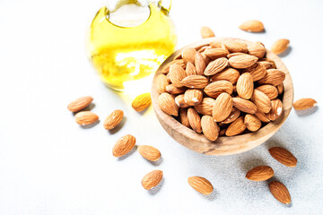 Almond nuts and almond oil at white background. Healthy fat, omega 3 sources.