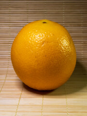 Bright Orange Featuring Textured Skin Sitting on Wooden Surface