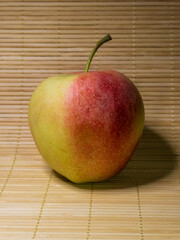 Fresh Red and Yellow Apple on a Wooden Bamboo Surface