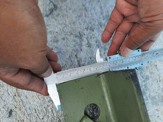 Accurate measurement of a steel frame using a caliper for construction purposes
