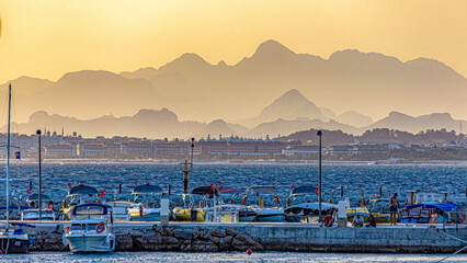 Panorama of Side beach with mountains in haze at sunset, Antalya, Turkey	
