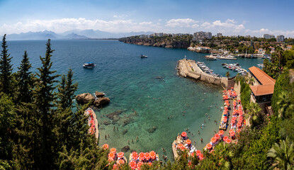Beach full of sunbathers and  Antalya marina from Kaleici viewpoint, Mediterranean Turkey	
