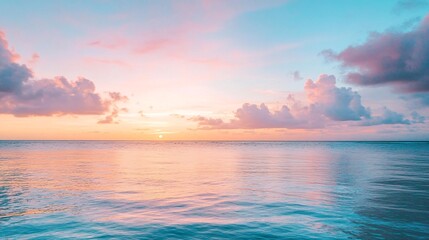 Obraz premium Gentle Waves Rolling on a Quiet Beach at Dawn with a Sky Blushing in Soft Pink and Blue Hues