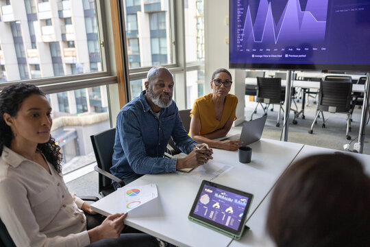 Mature African American businessman listening in an office meeting