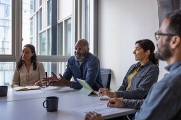 Mature African American businessman leading a business meeting