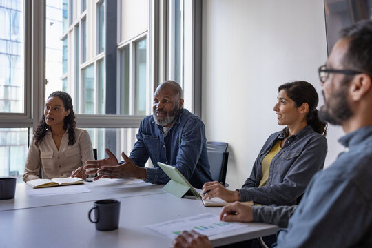 Mature African American businessman leading a business meeting