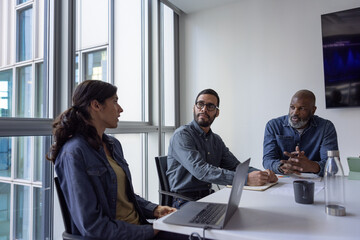 Hispanic businessman listening to a colleague in an office meeting