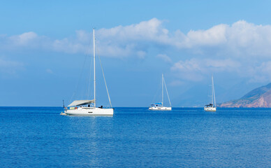 sailing yacht boats with white sails in blue sea . Luxury yachts Regata.Sailing in the wind through...