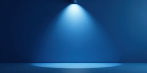 A Single Spotlight Illuminates a Deep Blue Wall and Empty Surface, Perfect for Product Displays or Abstract Backgrounds