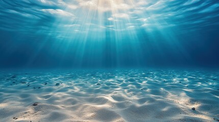 Serene underwater seascape: soft sandy ocean floor extending to a hazy distant horizon
