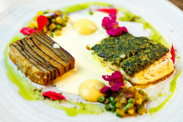 Pike-perch fillet. Potato gratin, warm yellow beet-turkey bean salad, parmesan dressing. Delicious seafood fish closeup served on a table for lunch in modern cuisine gourmet restaurant