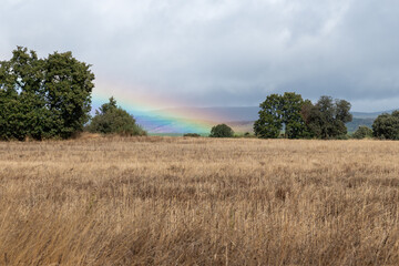 Big Rainbow in Santa Catalina de Somoza in the cloudy sky on the Camino de Santiago