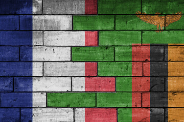colourful painted big flag of france and flag of zambia on a massive old brick wall background....