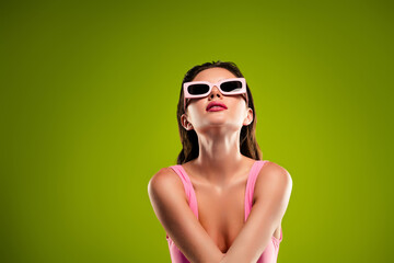 Photo of attractive stunning lady with cool sunglasses look up green copyspace background enjoying