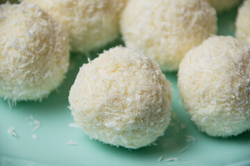 Delicious homemade candies with almonds and coconut flakes. Candies close-up macro on a light background