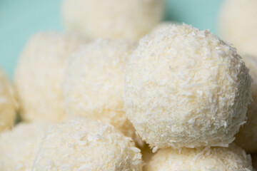 Delicious homemade candies with almonds and coconut flakes. Candies close-up macro on a light background