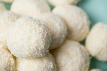 Delicious homemade candies with almonds and coconut flakes. Candies close-up macro on a light background