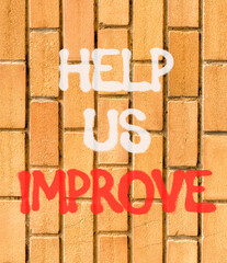 Help us improve symbol. Concept words Help us improve on beautiful brown brick wall. Beautiful brown brick wall background. Business motivational help us improve concept. Copy space.