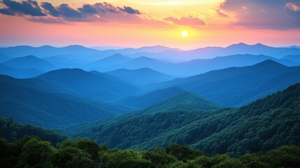 Obraz premium Scenic panoramic view of layered mountain ranges at sunset with vibrant colors