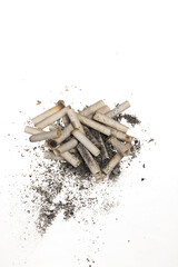 Close up white smoked cigarattes and burnt tobacco grains isolated on white background. Concept of harm of smoking. Free area for text