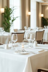 Elegant restaurant table setting with candles and fine glassware, creating a sophisticated and intimate dining ambiance.