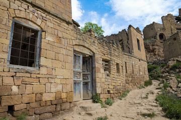 Ruins of an old traditional mountain house in the abandoned village of Gamsutl on a May morning. Dagestan. Russian Federation