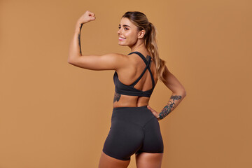 An Empowered Fitness Model is Showcasing Not Only Strength but also Impressive Confidence