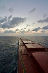 A merchant ship underway at sea during Sun rise