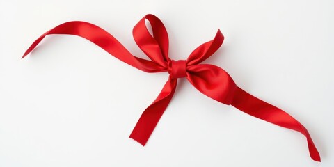 A vibrant red satin ribbon elegantly tied in a single bow, showcasing its luxurious texture and smooth curves against a pristine white backdrop.