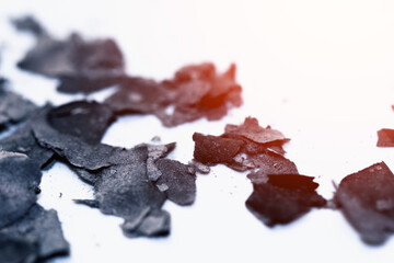 Scattered burnt ashes and debris on a white background