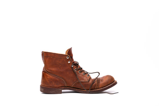 An old leather boot against a white background