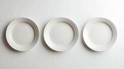 Artistic Display of Three Unique Plates Mounted on a Minimalist White Wall Creating an Elegant and Contemporary Aesthetic That Evokes a Sense of Calm and Sophistication in Modern Decor