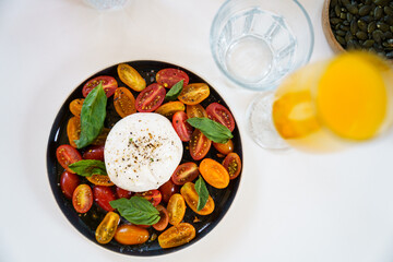 Burrata with cherry tomatoes and fresh basil