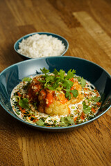 Roasted cauliflower with spicy sauce and herbs