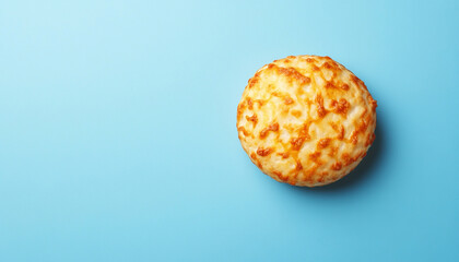 A deliciously baked cheese bread on a blue background, perfect for appetizing visuals.