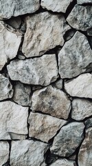 Natural stone wall texture with irregular grey and beige rocks