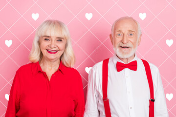 Portrait of attractive cheery gray-haired couple festal occasion time isolated over pink pastel color background