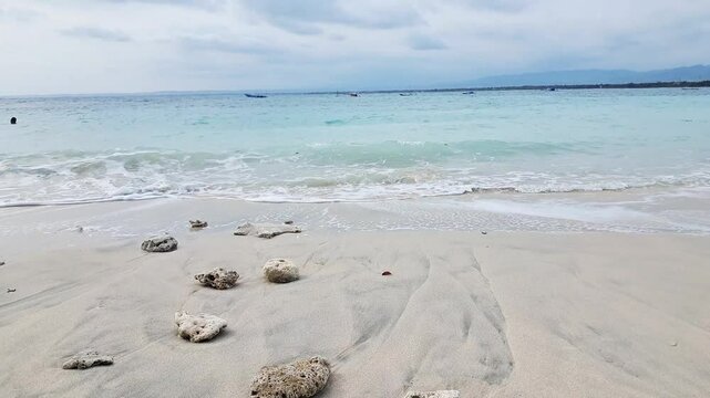Landscape sand beach sea on sunlight in the holiday season. Gentle waves Pangandaran beaches Indonesia.