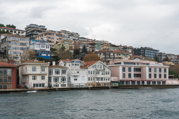 Fototapeta premium Beautiful view of the Bosphorus shore on a cloudy day, full of residential houses, Istanbul, Turkey.