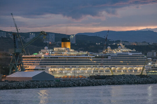Modern cruise ship cruiseship liner Pacifica in dry dock maintenance modernization process at shipyard in Marseille Provence, France  with dock and cranes	