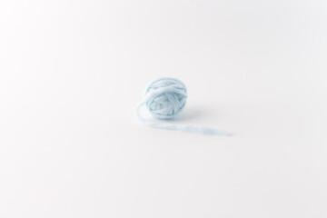a ball of light blue yarn on white surface. part of creative process, Fun and simple DIY project idea for creative crafting, kids' activities, and educational art projects using everyday materials,